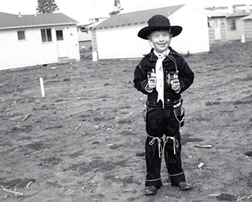 Tom Rohlffs as a child in his backyard