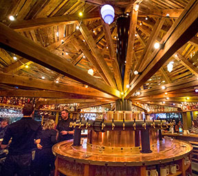 McMenamins new Cedar Hills Pub features a large round bar with 40 taps of beer and cider from McMenamins and guest breweries and cideries. Above the bar is a large propeller that once belonged to pioneering Portland pilot Tex Rankin. 
