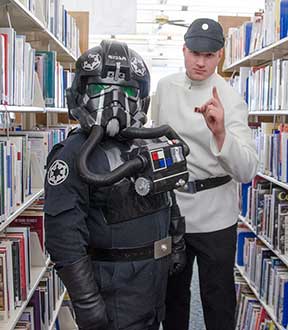 Star wars characters pose in the library.