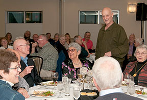 Founder Chuck Richards chats with members at the banquet for those who joined during the first years of the club.
