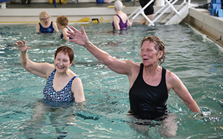 Multiple times per week, Kathy Chaney (right) leads popular aquatic fitness classes in the shallow end of the pool.