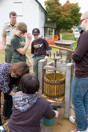 Boy scouts making cider