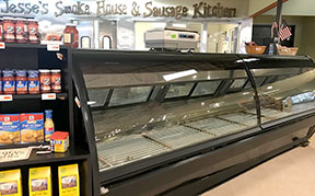 The meat counter is empty. Meat is located in a different case.
