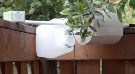 makeshift tapwater setup on a fence