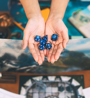 teen holding blue dice