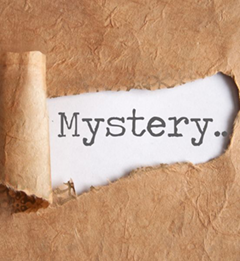 the word "mystery" behind torn paper