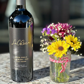 bottle and flowers on counter