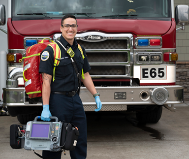 smiling emt for tvfr walking in front of fire engine