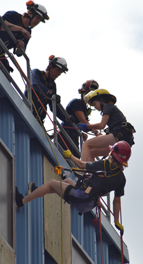 young prospective firefighters climb building