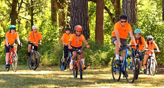 bike riders in orange shirts