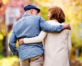 man and woman walking with arms around each other